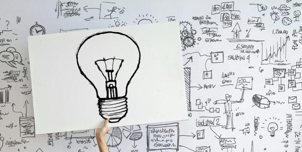 hand holding up a lightbulb idea sign
