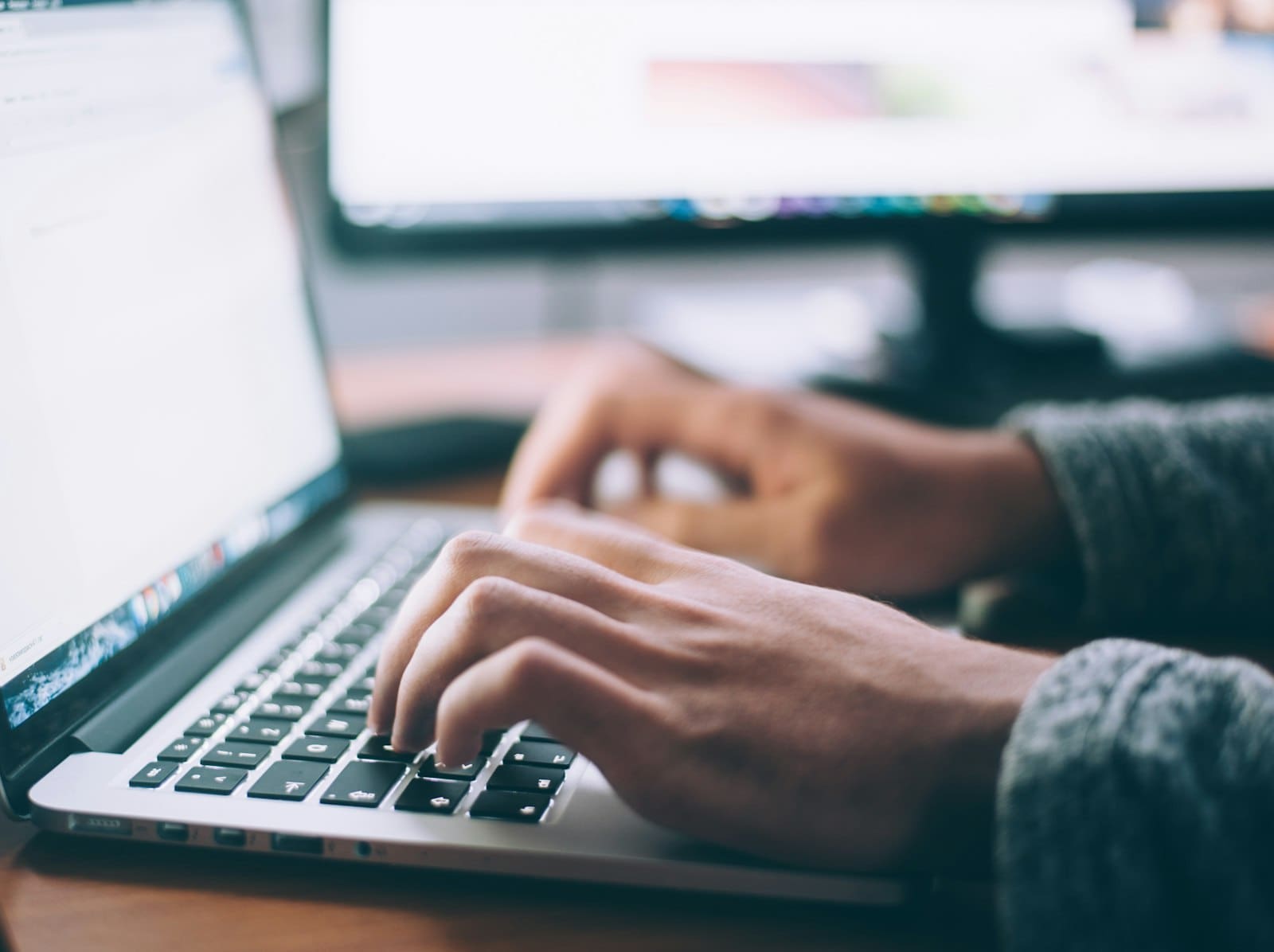 Someone searching on a laptop