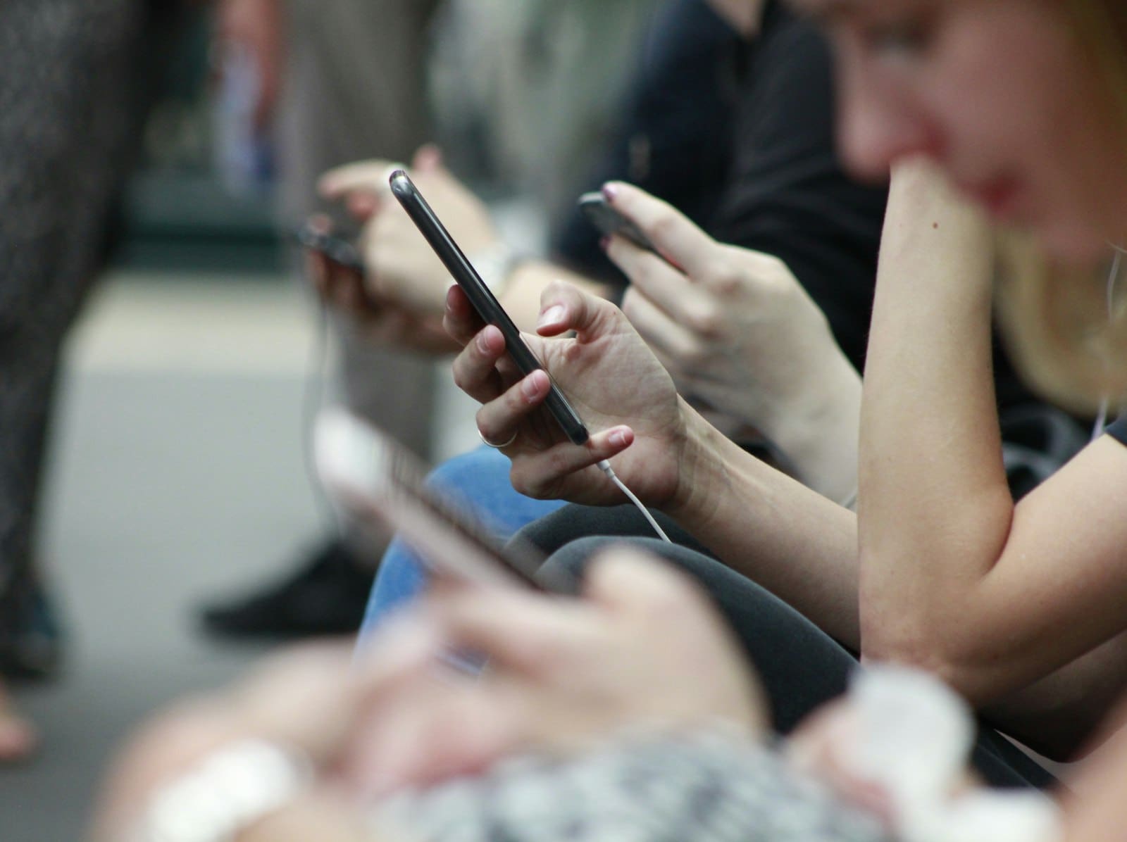 Commuters scrolling their phones