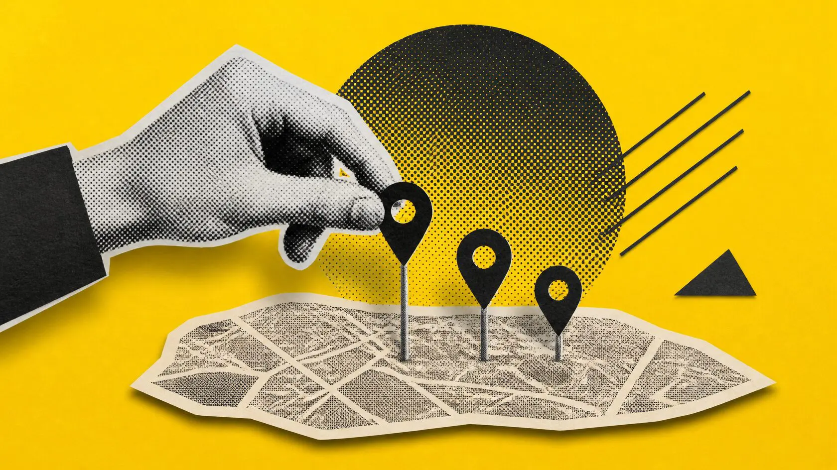 A hand pushing three map pins into a paper street map, illustrating the Google local pack